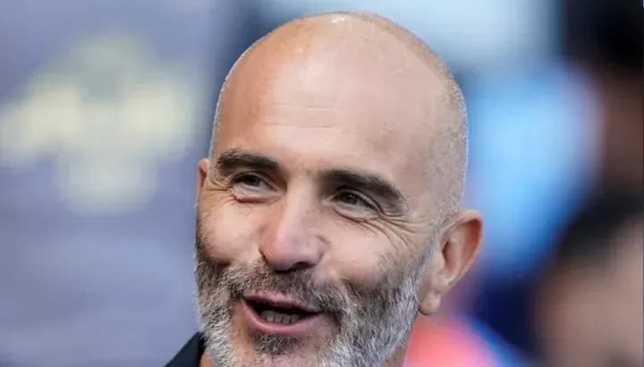 Coach smiling during match day preparations