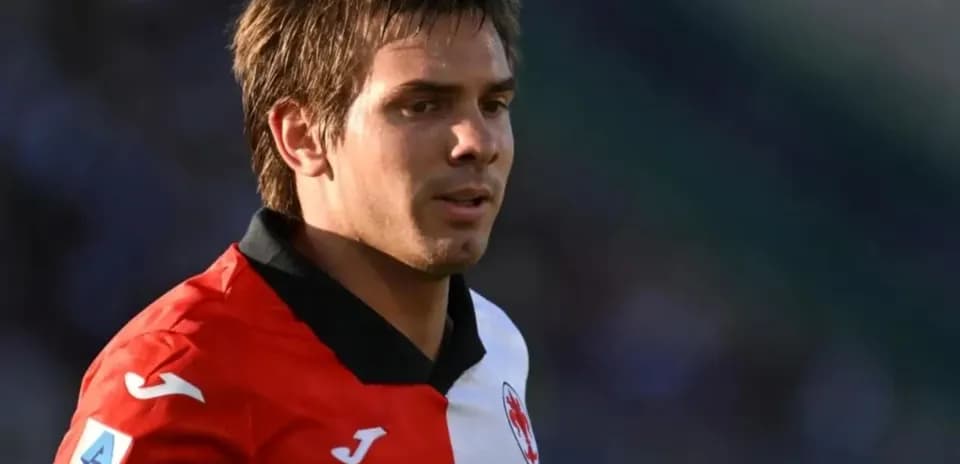 Player wearing red and white jersey during match