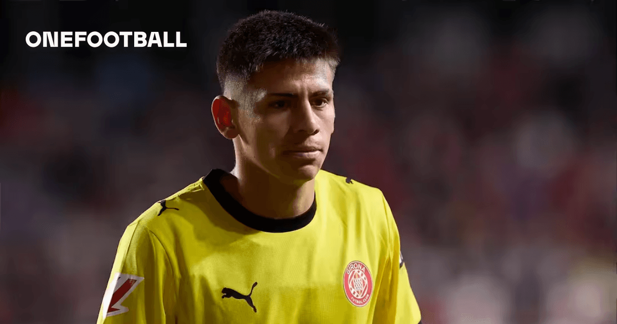 Goalkeeper in yellow jersey walking on the field