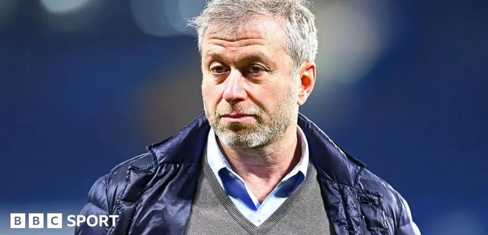 Man in jacket standing in stadium environment