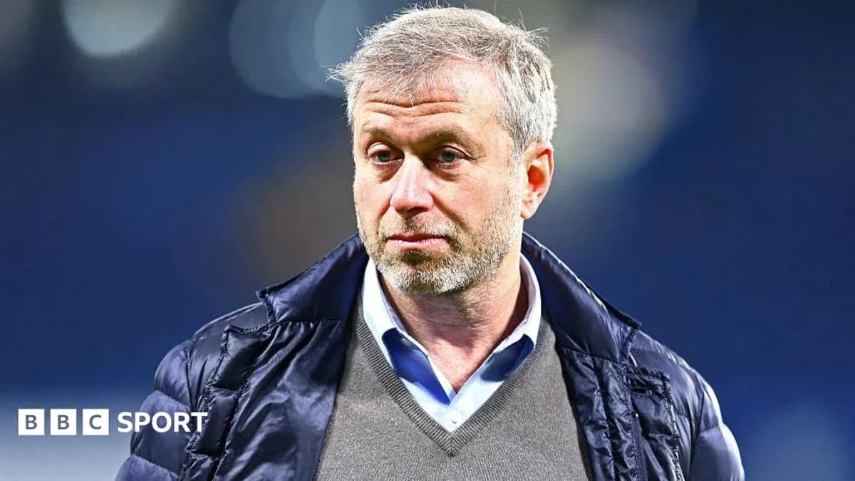 Man in jacket standing in stadium environment