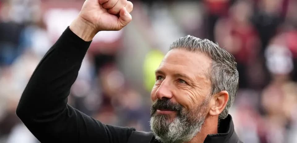 Coach celebrating with raised fist at stadium