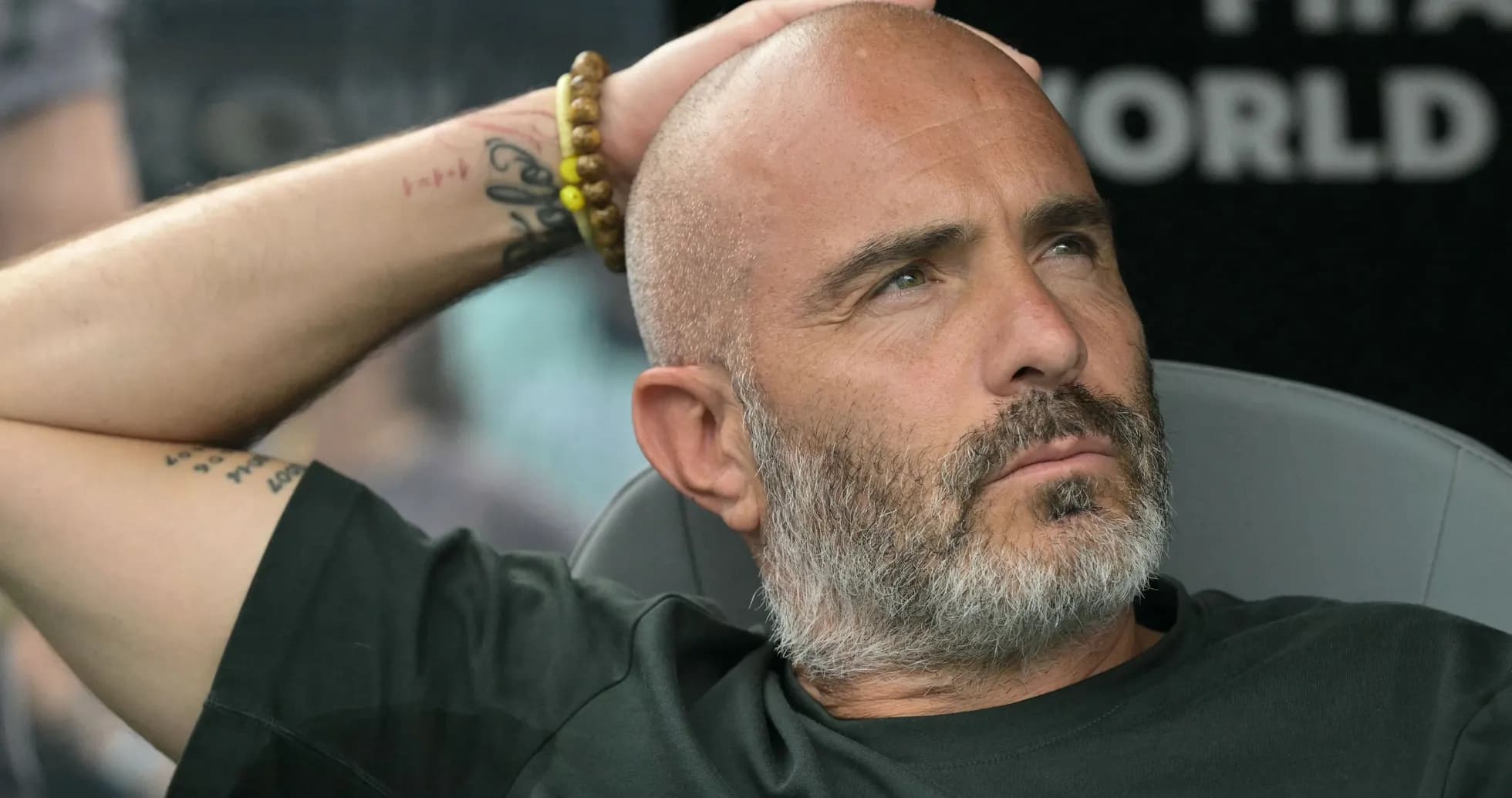 Coach sitting on the bench during a match