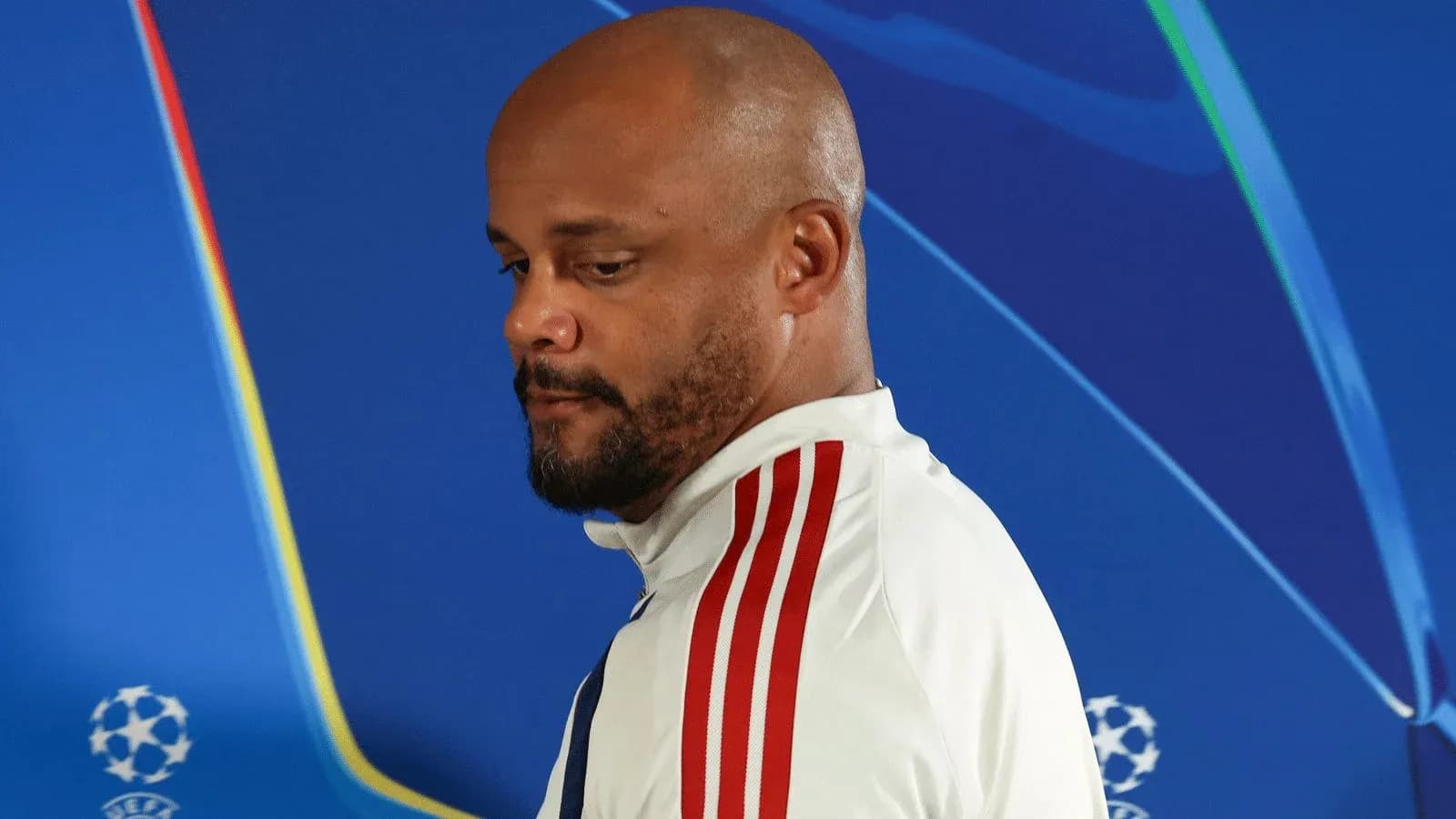 Man in white jacket with red stripes at event