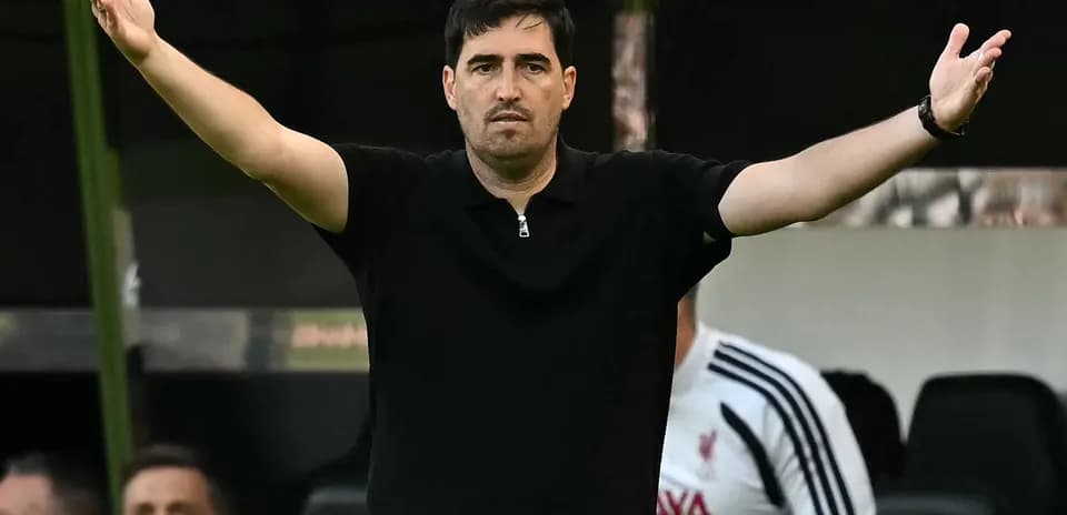 Coach gesturing during a football match on sidelines