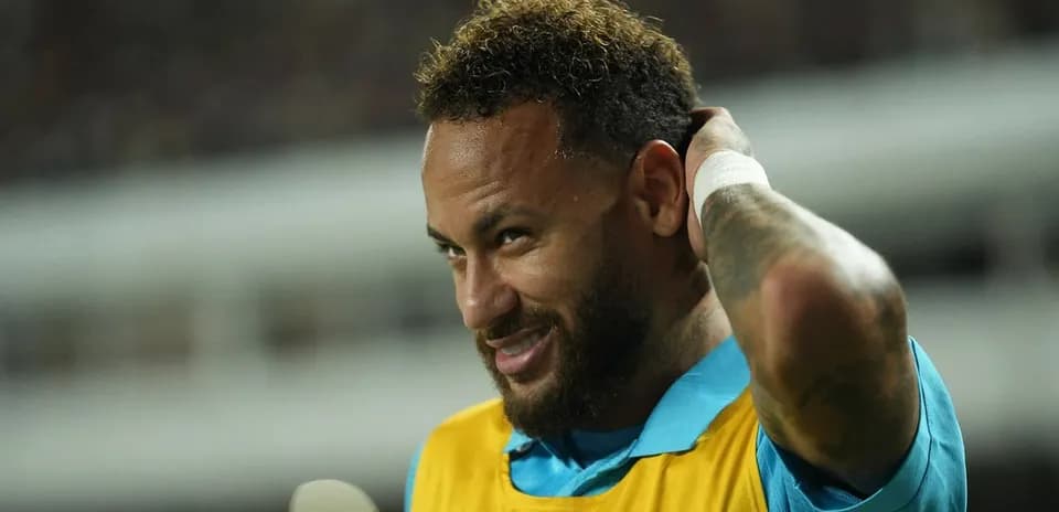 Neymar adjusting his hair during a match