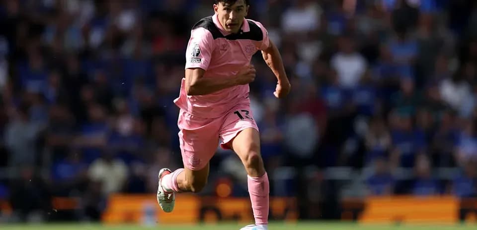 Player sprinting towards the ball on the field