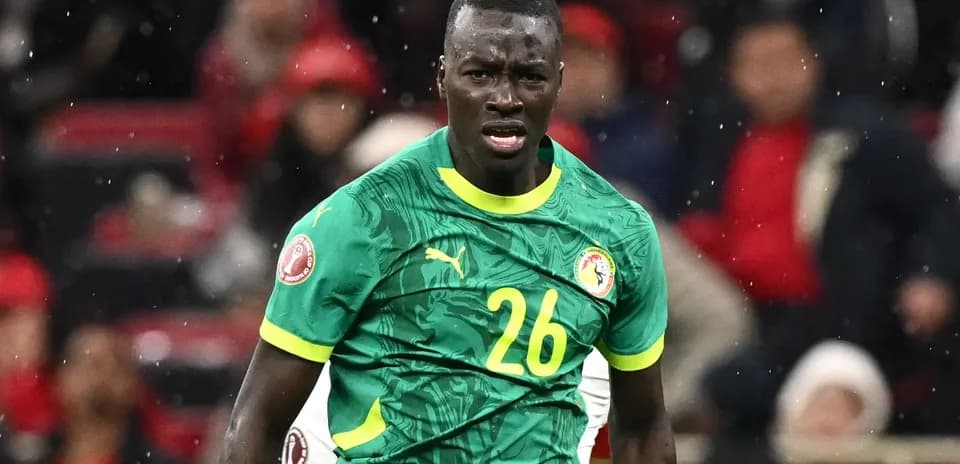 Player wearing green jersey during soccer match