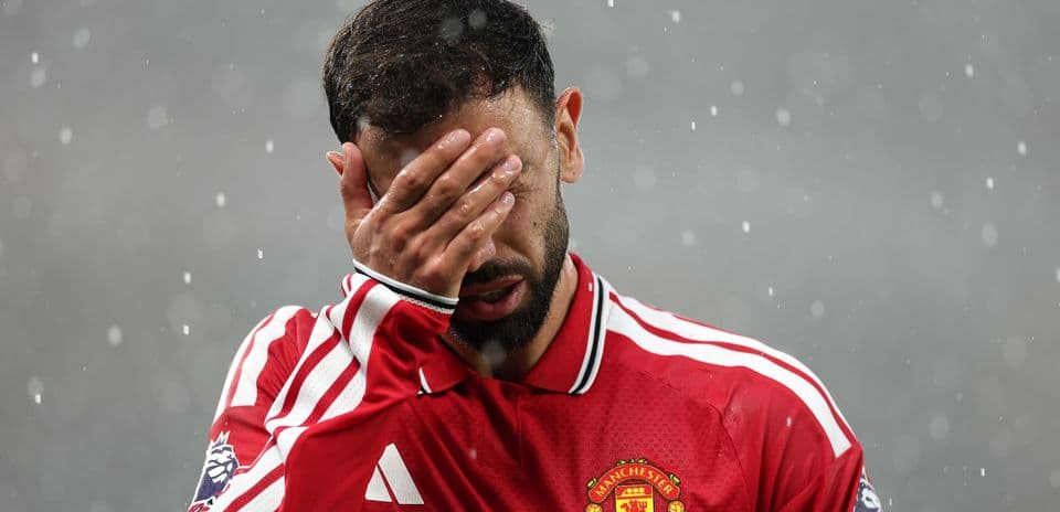 Bruno Fernandes covering his face in rain