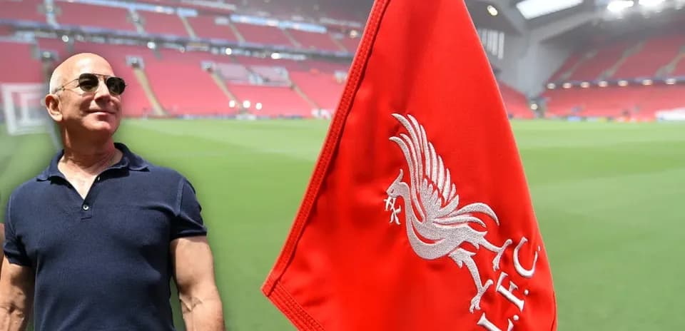 Person beside Liverpool FC corner flag at stadium