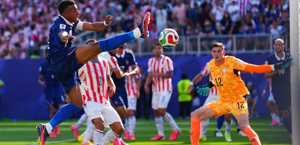 Player kicking ball during match with goalkeeper ready