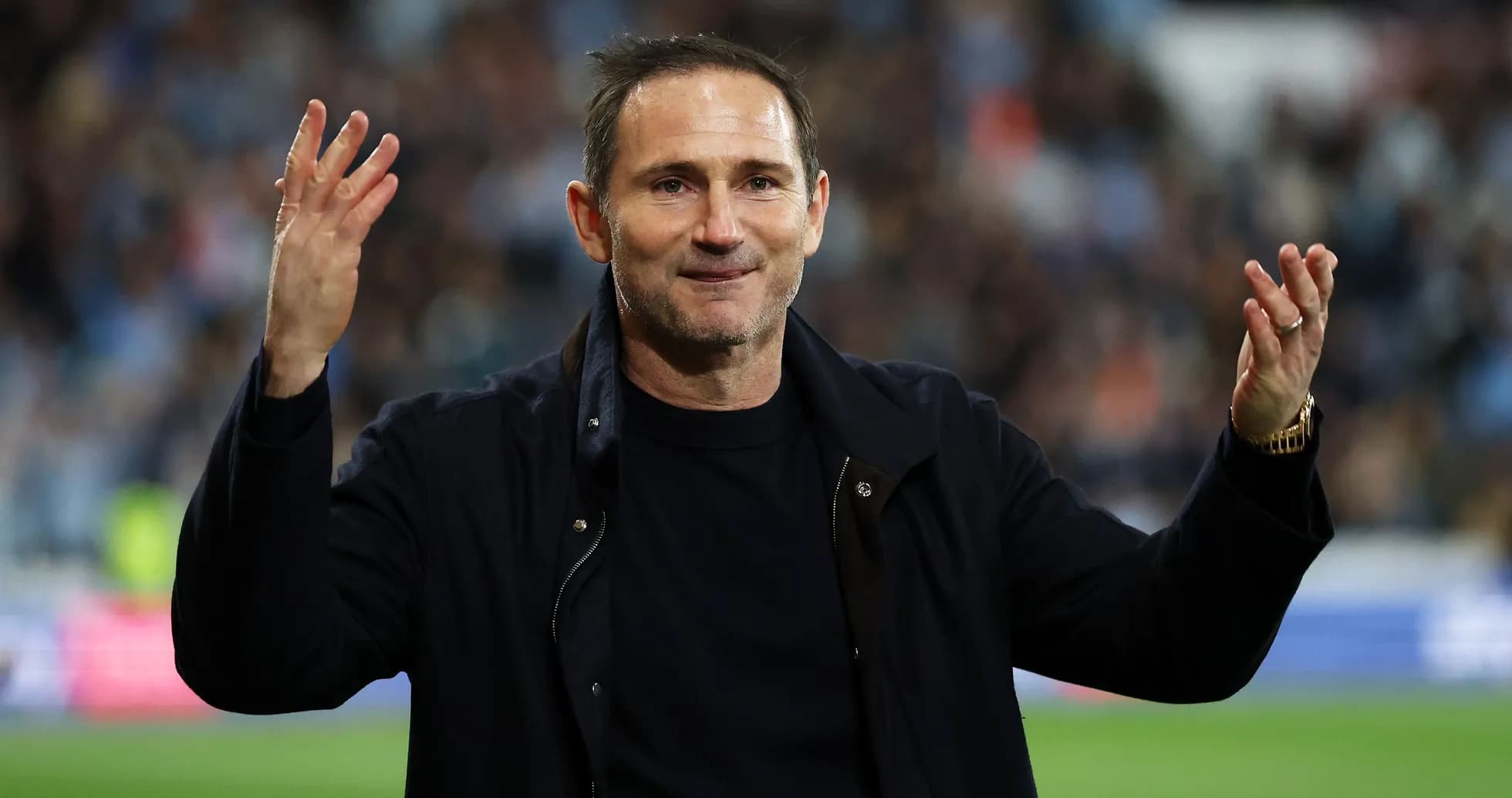 Manager gesturing to fans after match