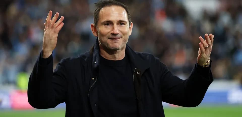 Manager gesturing to fans after match