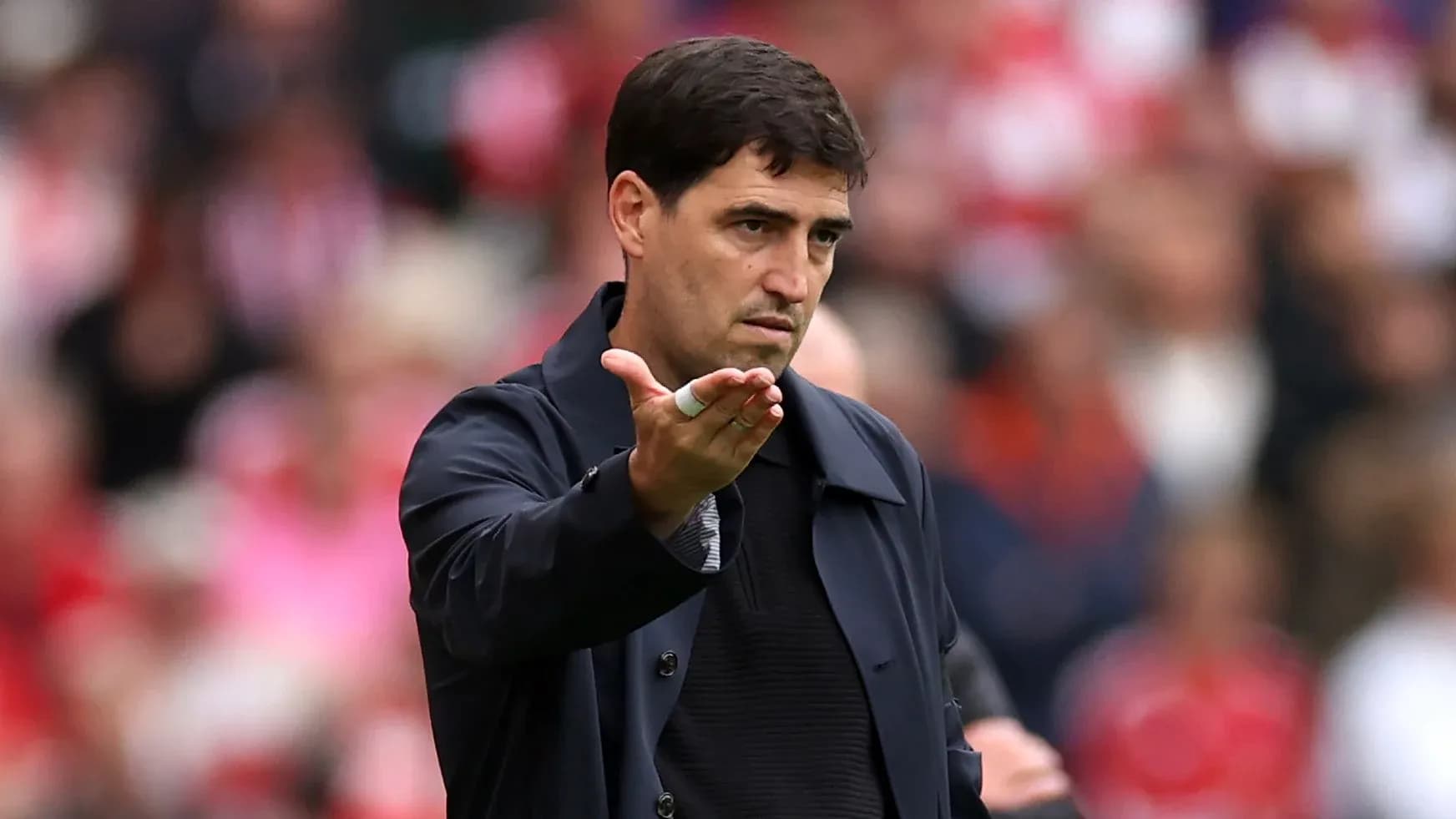 Coach gesturing during a football match on field