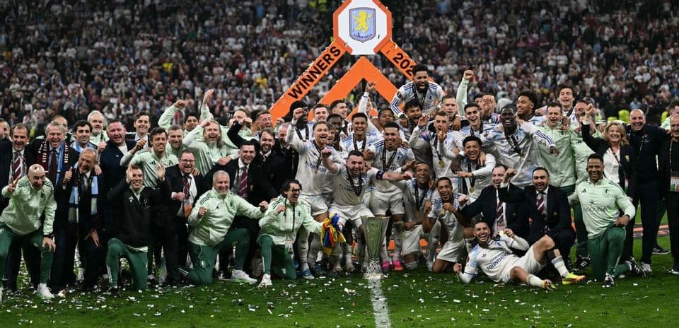 Team celebrating victory with trophy at stadium