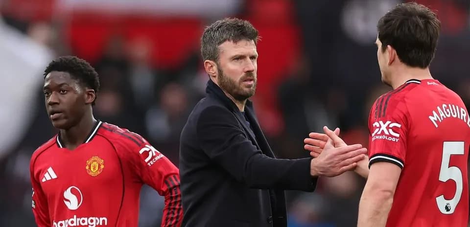 Manchester United players and coach interacting on pitch