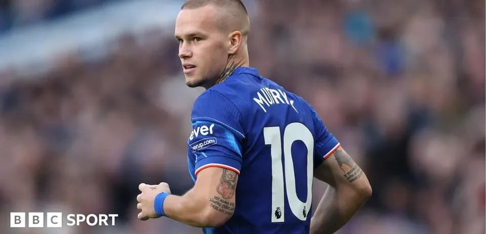 Player in blue jersey looking back during match