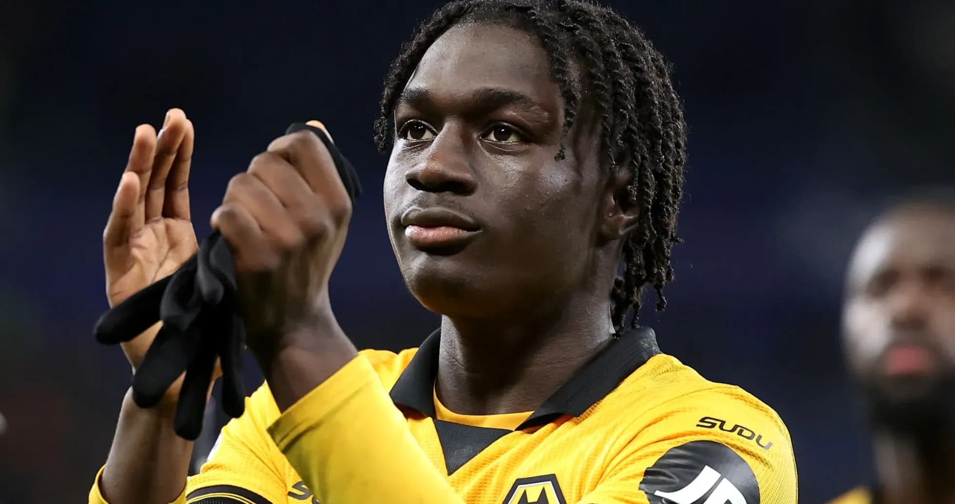 Player applauding while wearing team jersey