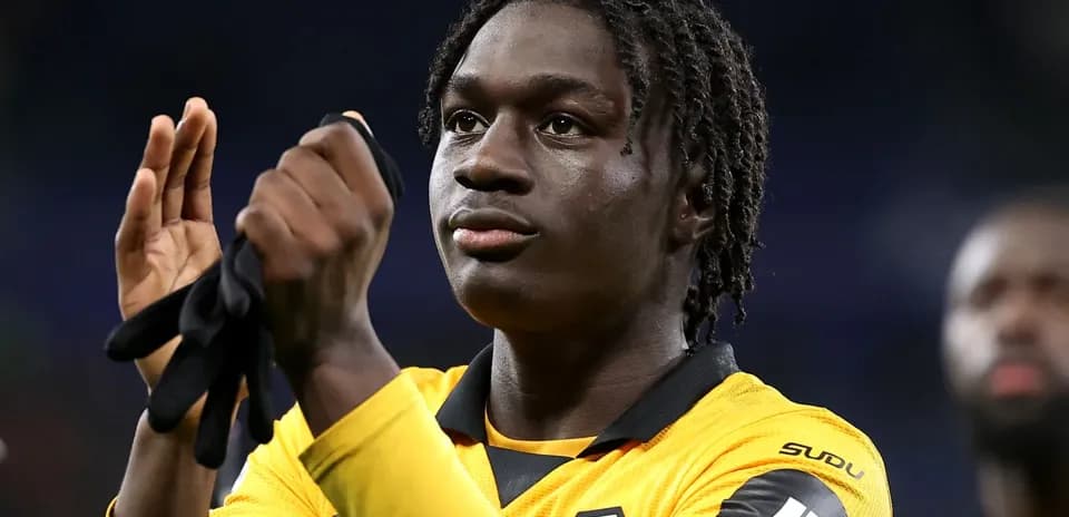 Player applauding while wearing team jersey