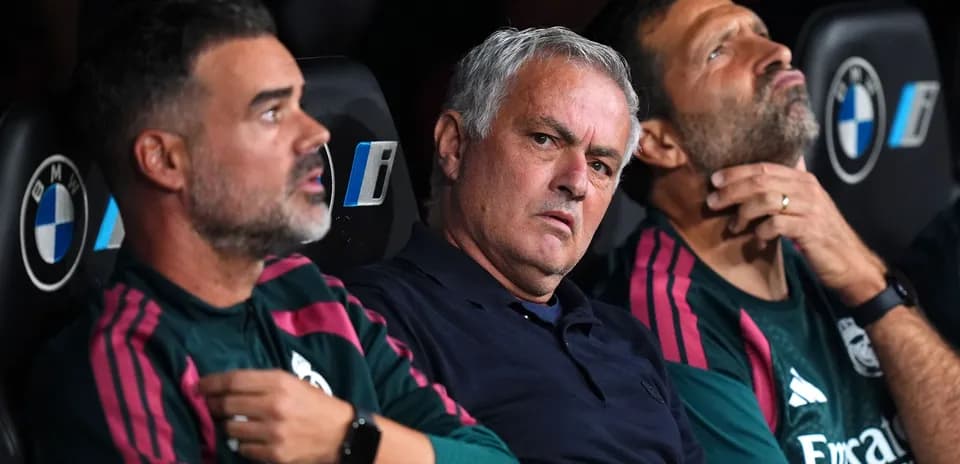Coaching staff sitting on the bench during match