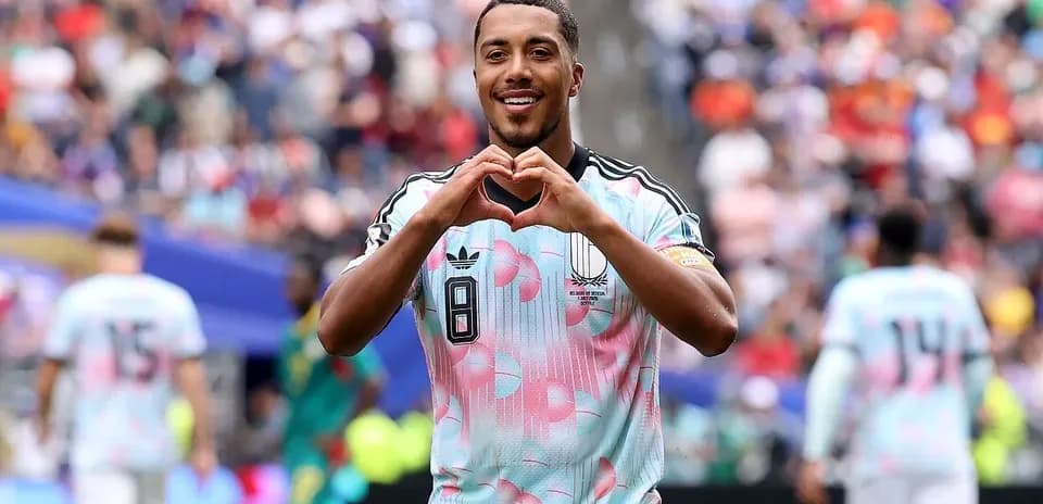 Player celebrating by making heart gesture on field