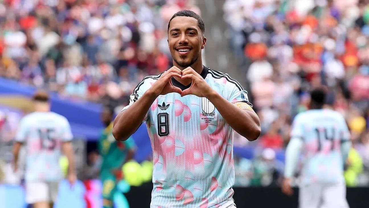 Player celebrating by making heart gesture on field