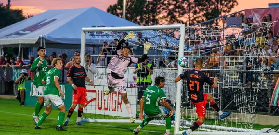 Goalkeeper attempting to save during match