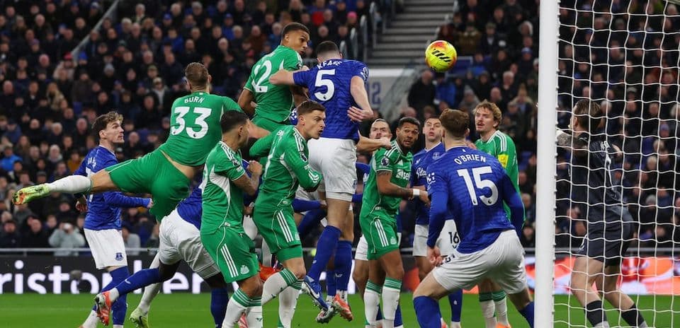 Players contesting a corner kick during match