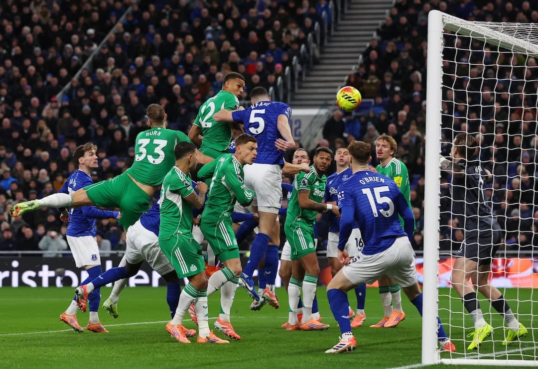 Players contesting a corner kick during match