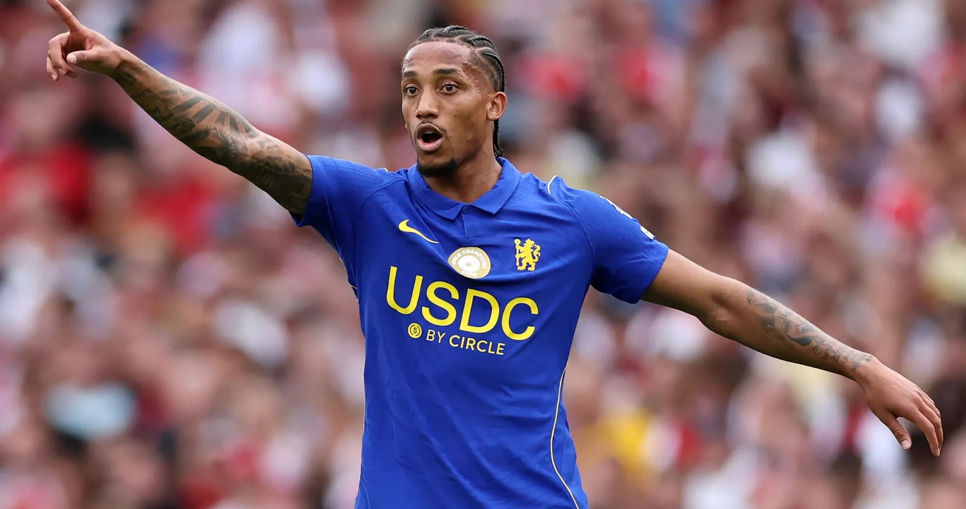 Player gesturing during match wearing Chelsea kit