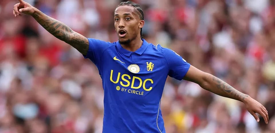 Player gesturing during match wearing Chelsea kit