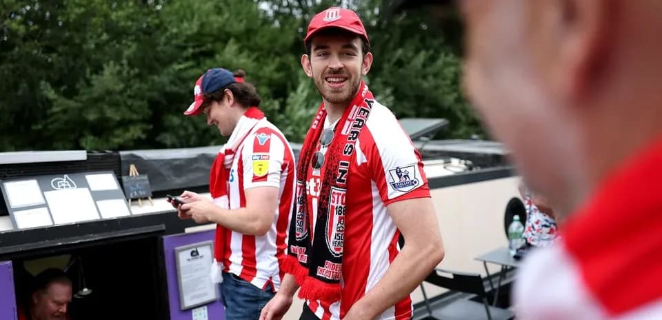 Fans wearing team jerseys at a sporting event