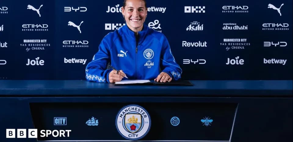 Player signing contract at Manchester City press event