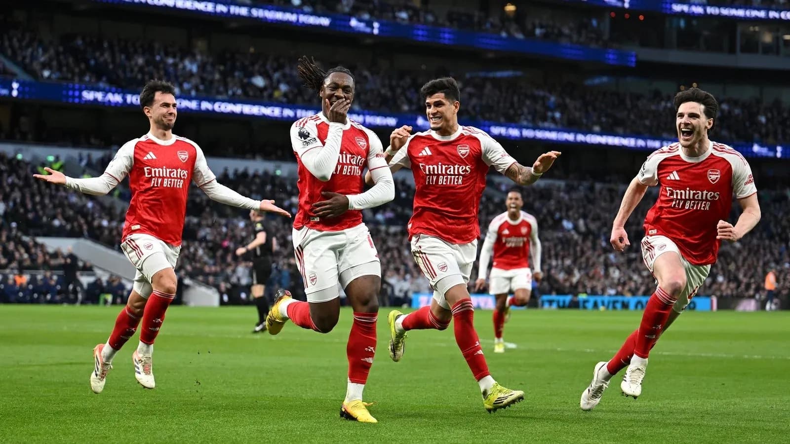 Arsenal players celebrating a goal on the field