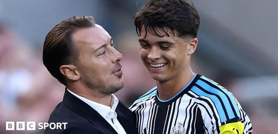 Coach and player celebrating after match at stadium