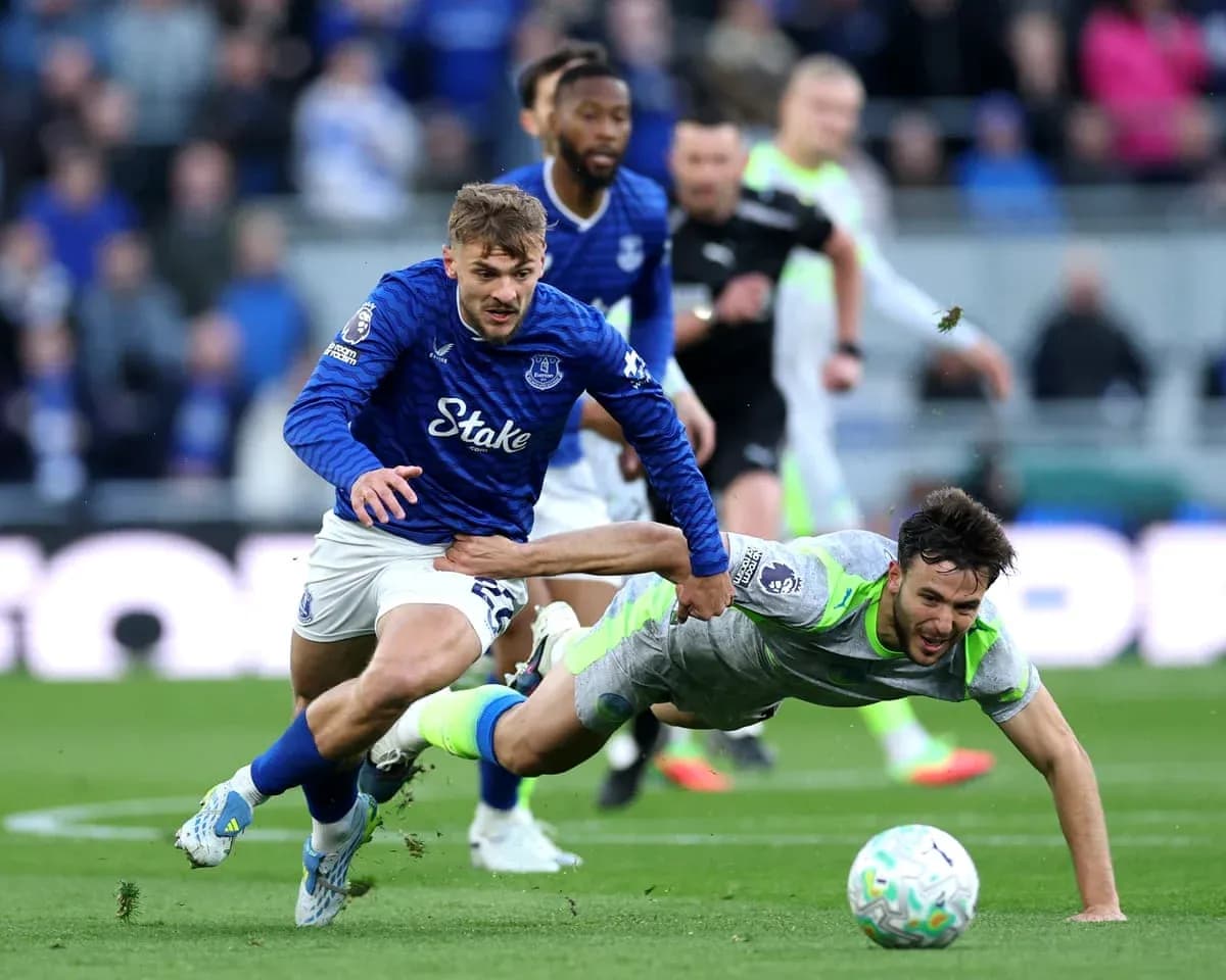 Everton player tackling Manchester City opponent