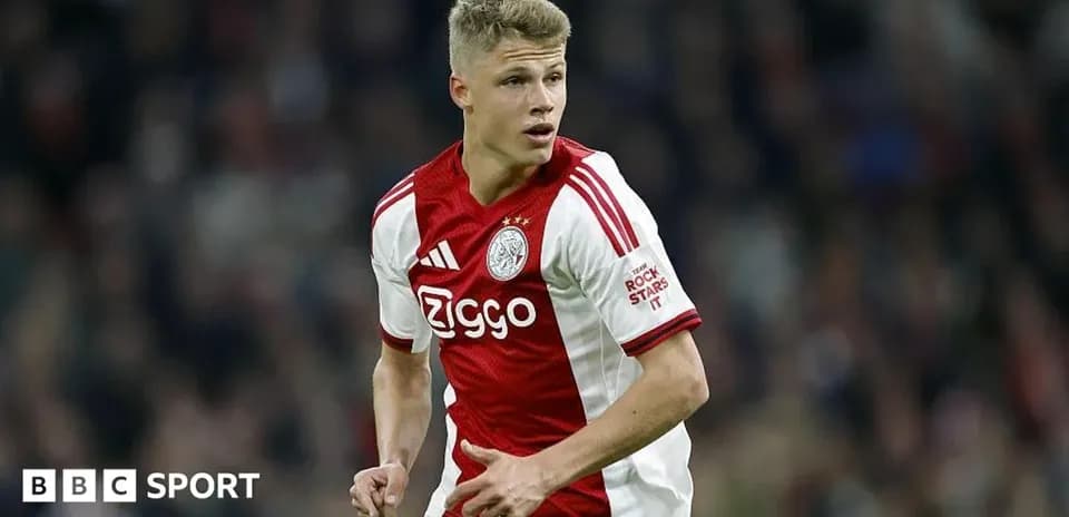 Player in Ajax jersey running on the field