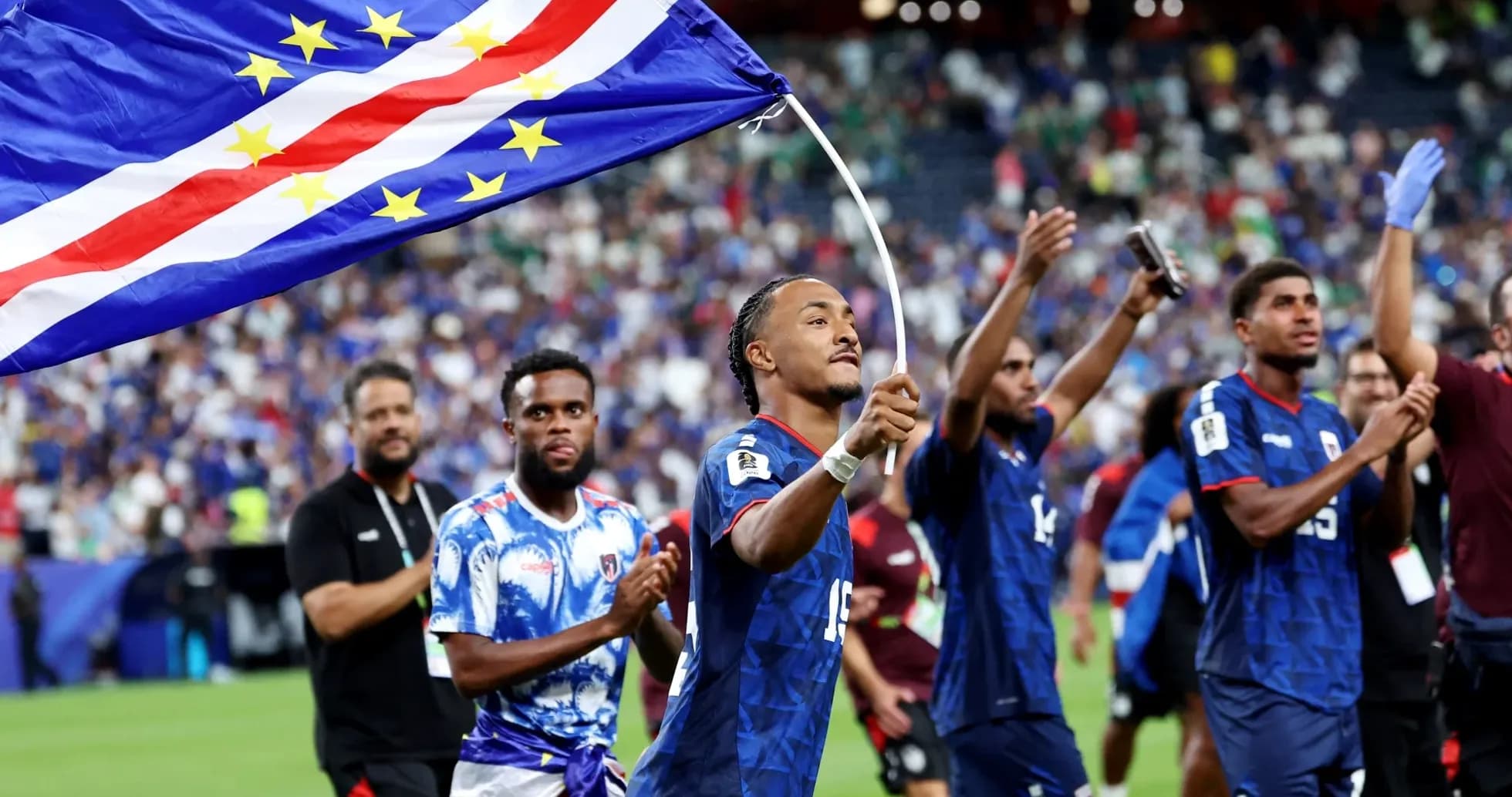 Players celebrating with Cape Verde flag after match
