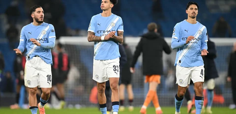 Three Manchester City players leaving the pitch