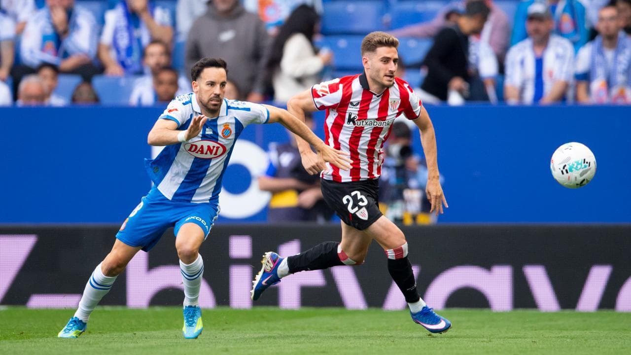 Espanyol player chasing Athletic Club opponent