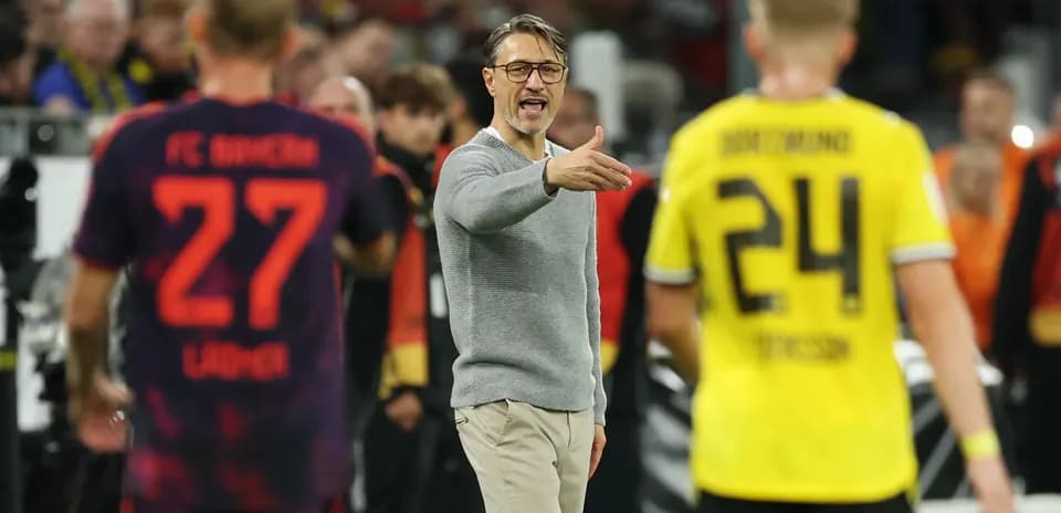 Coach directing players during a football match