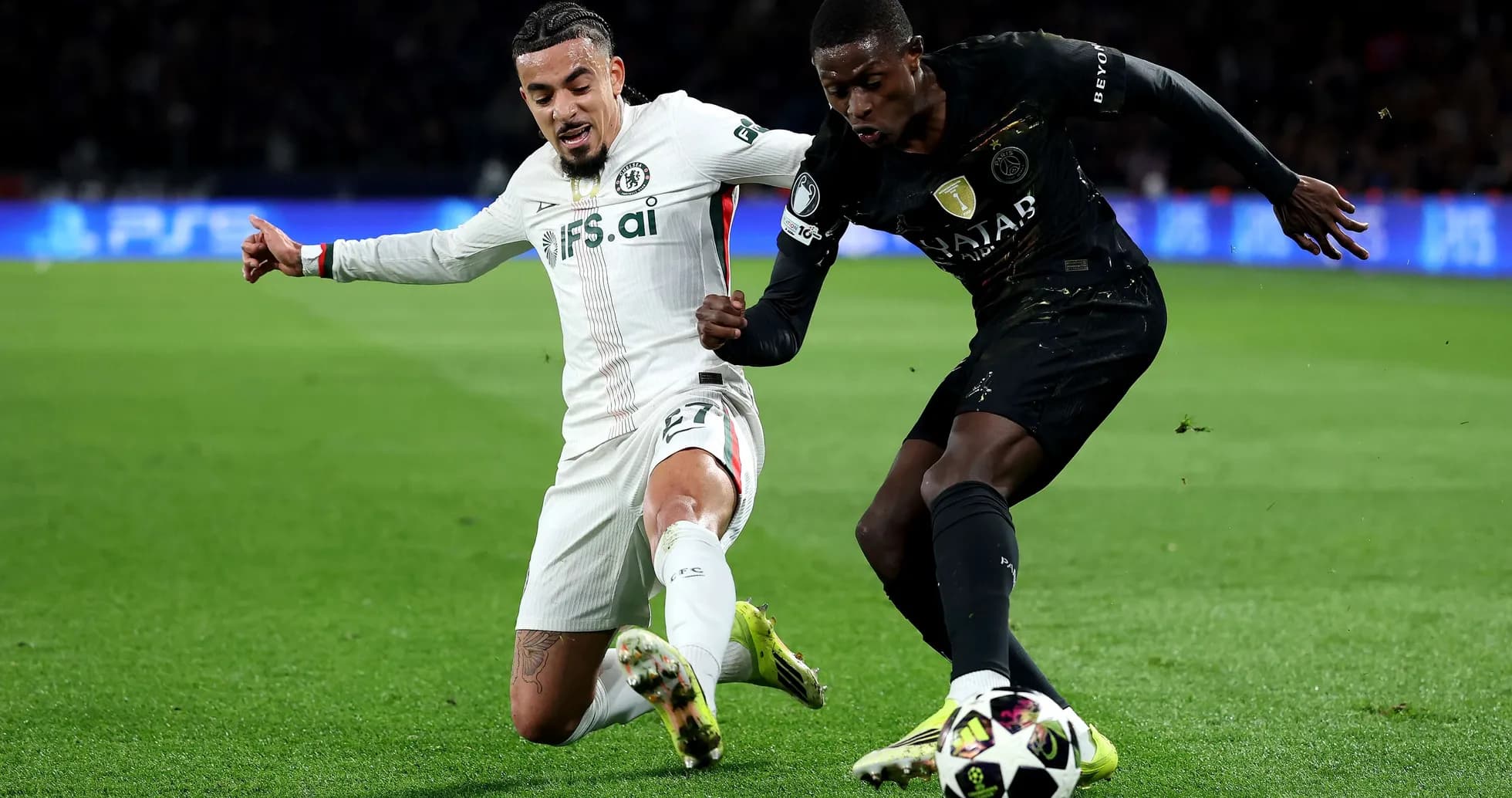 Chelsea player tackling Paris Saint Germain opponent