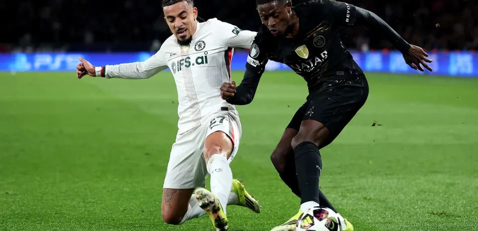 Chelsea player tackling Paris Saint Germain opponent