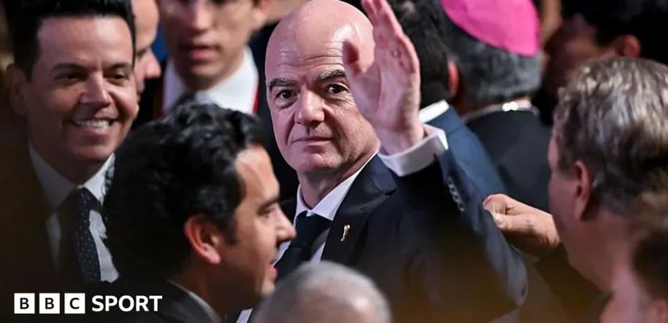 Gianni Infantino waving in crowded event setting