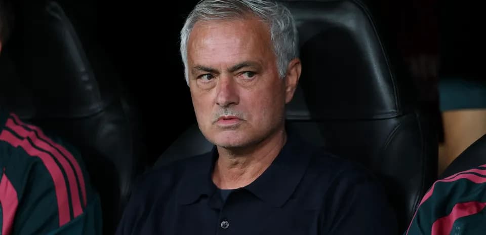 Manager sitting on the bench during a match