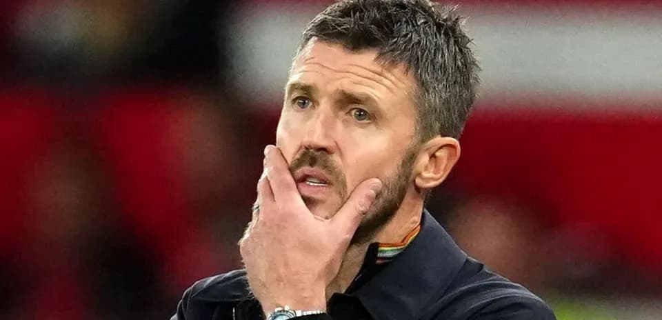 Coach with hand on face during match