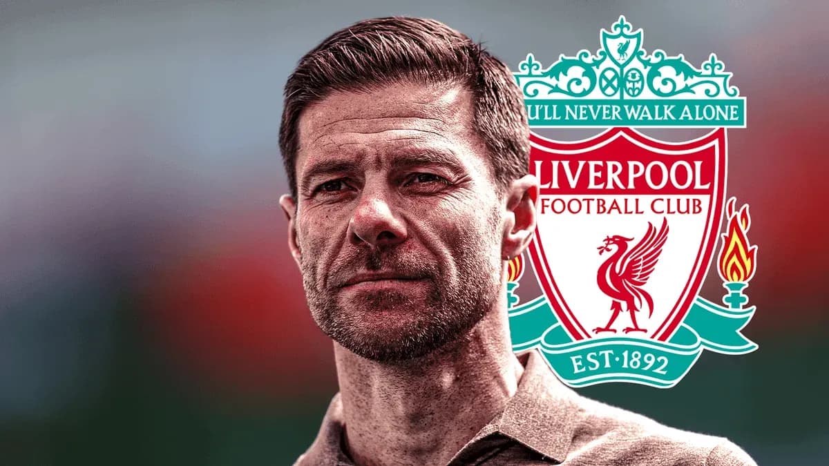 Man posing with Liverpool FC logo in background