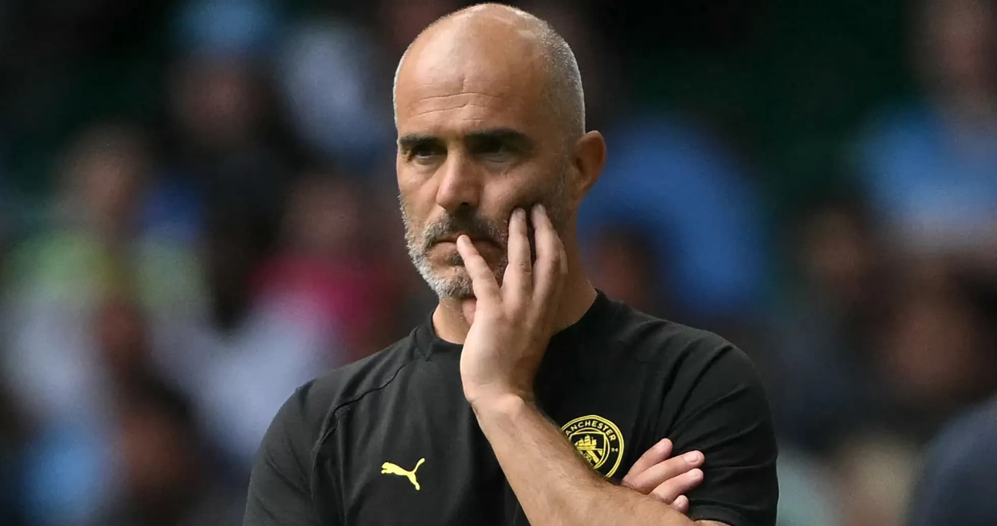 Coach observing match with hand on chin