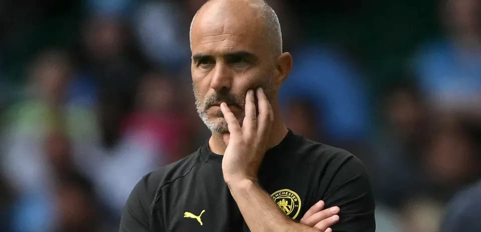 Coach observing match with hand on chin