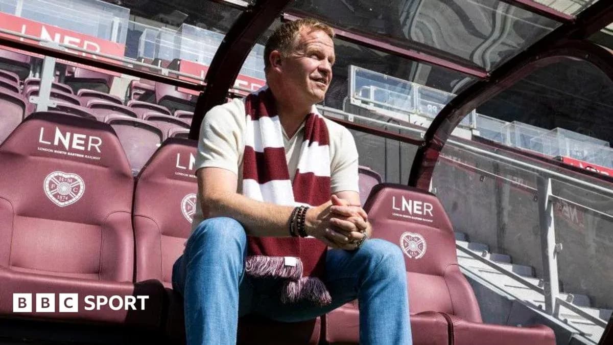 Manager seated on bench at football stadium